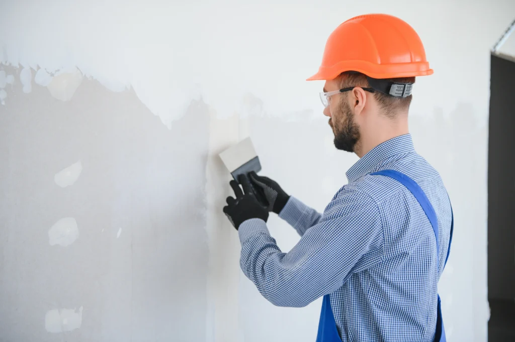 Edmonton drywall contractor applying joint compound for smooth wall finish