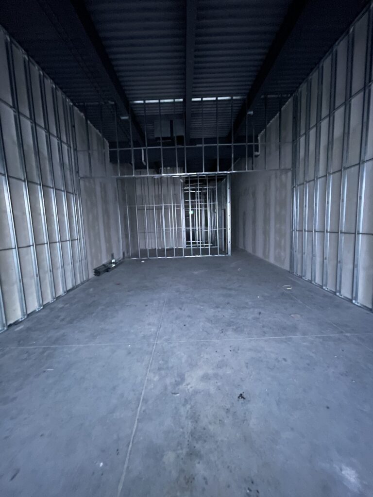 Commercial interior build-out with metal stud framing before drywall installation