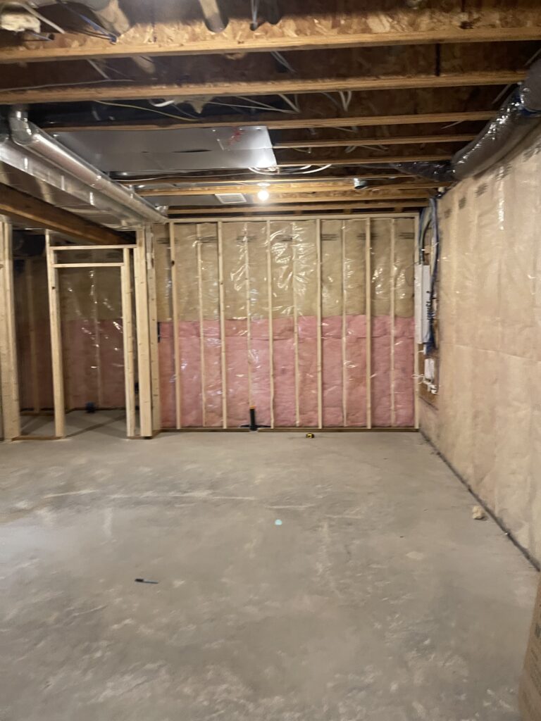 Batt insulation installed in wall stud bays during a basement renovation