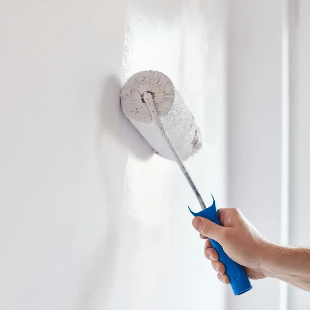 Professional painter applying white paint with a paint roller