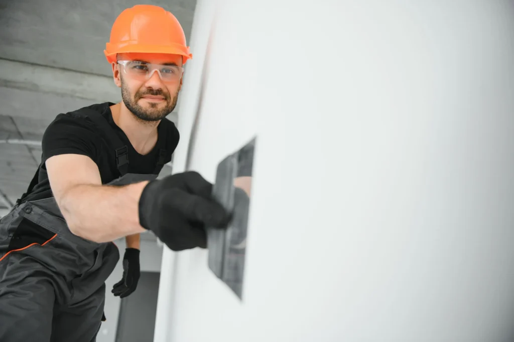 drywall installation taking place inside a heated construction space during winter in Edmonton