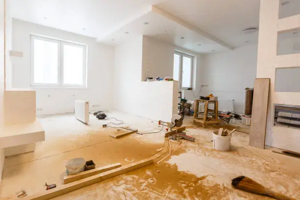 White room with wooden floor undergoing finishing