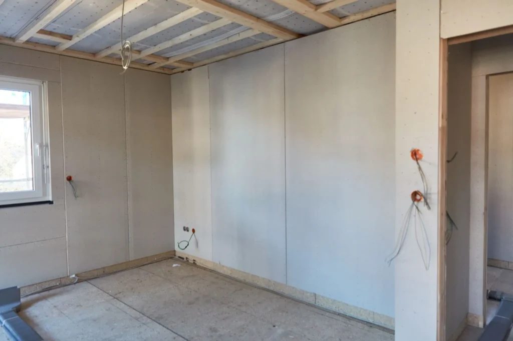 Visible paint failure and flashing on newly finished drywall in an Edmonton home