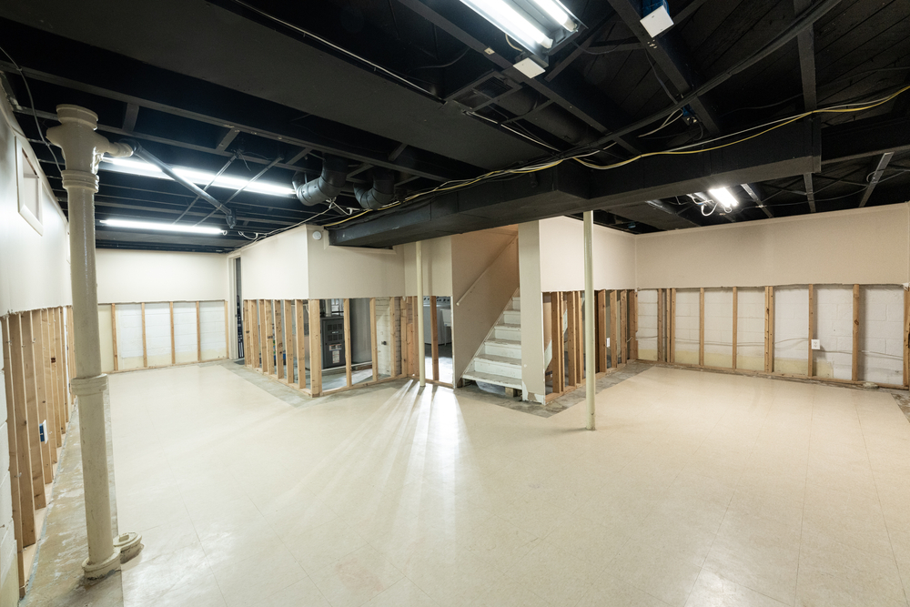 Basement during drywall installation with exposed framing